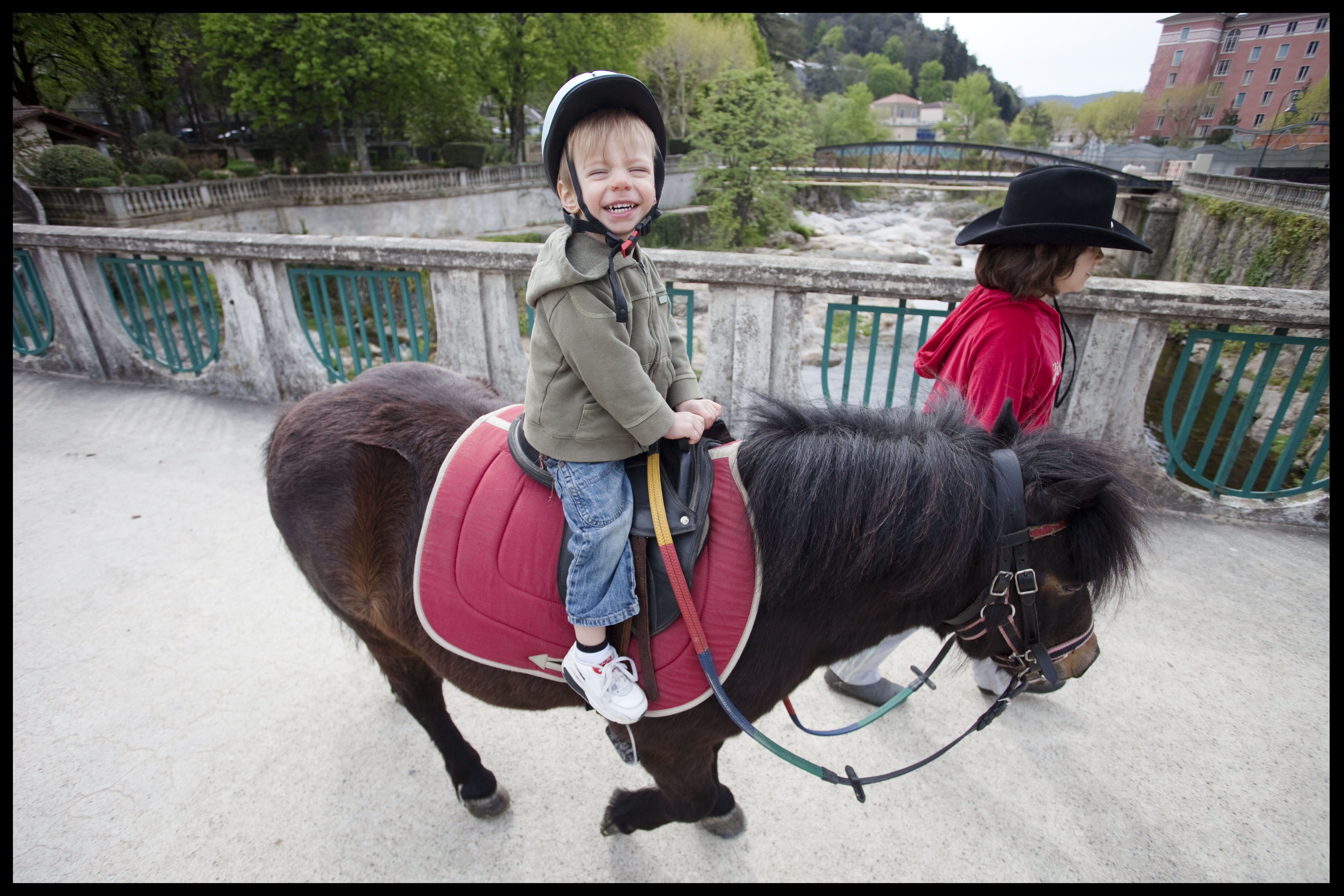 Little boy sitting on horse||||