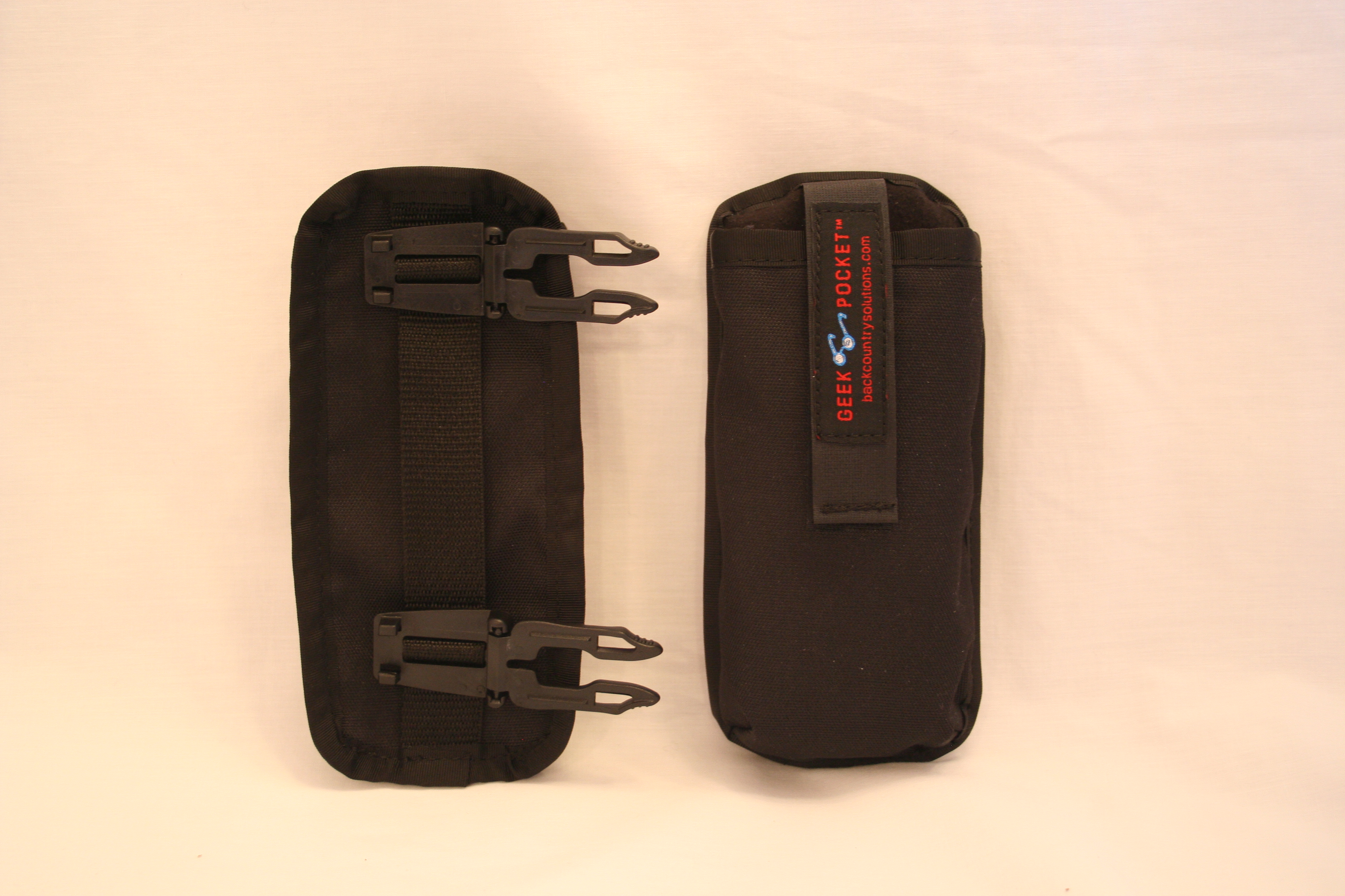 Front and Back - clips fold over and sandwich webbing.  
Behind top clip is a loop for inserting  a belt
