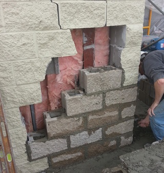 Block Laborer Repairing Damaged Wall Block Laborer Repairing Damaged Wall