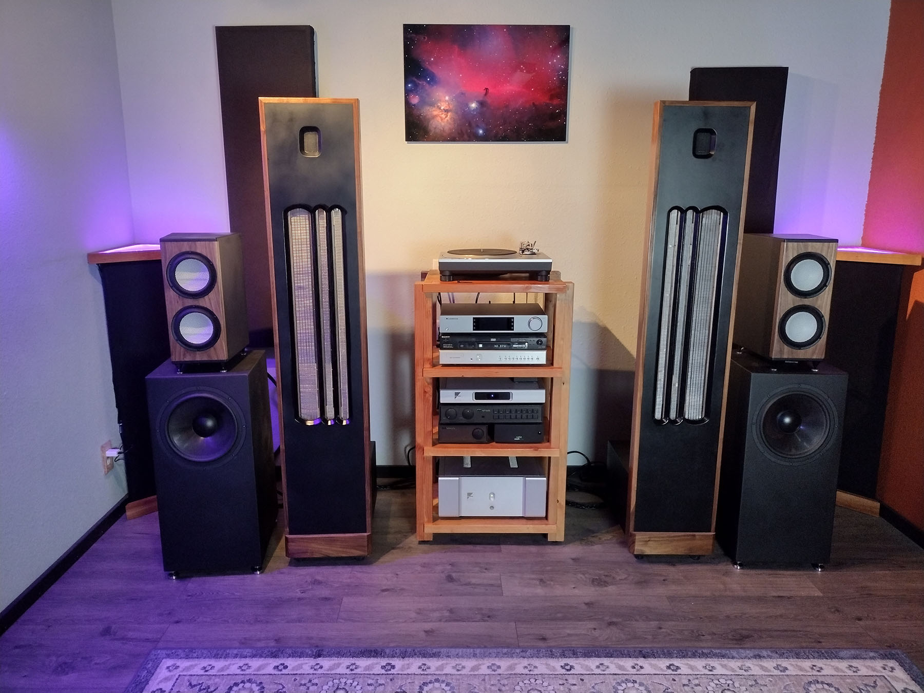 Pair of wooden floor-standing speakers in modern living room home audio setup