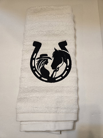 White hand towel featuring a horseshoe design