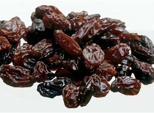 Happy child with glasses holding books and an apple on top