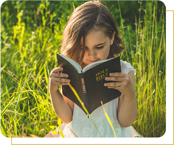 Little girl reading Bible