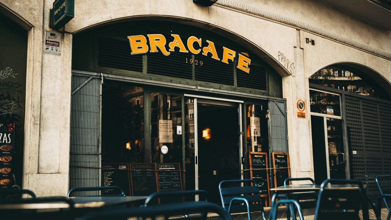 a restaurant with tables and chairs outside of it