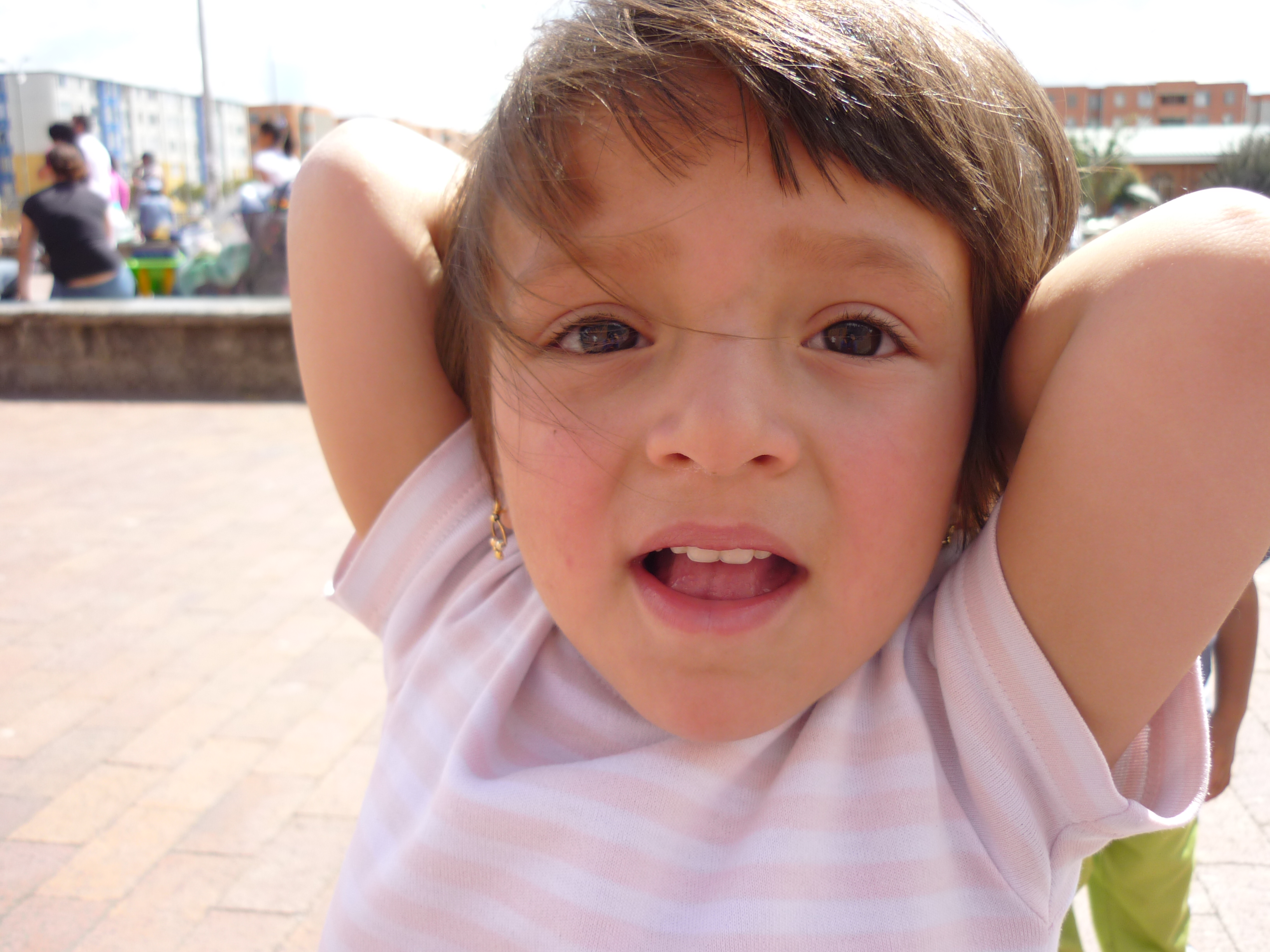 Happy child with glasses holding books and an apple on top
