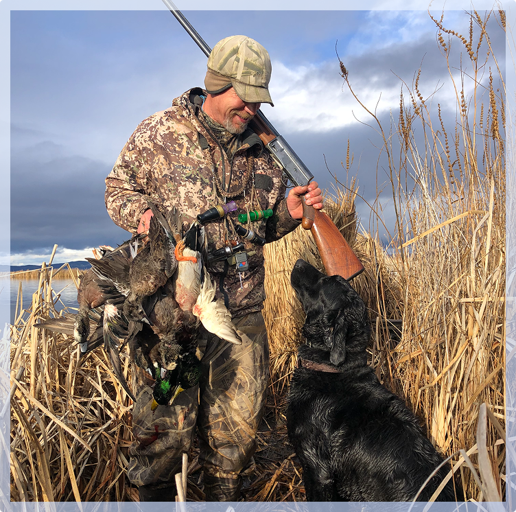 A hunter smiling down at his dogs A hunter smiling down at his dogs