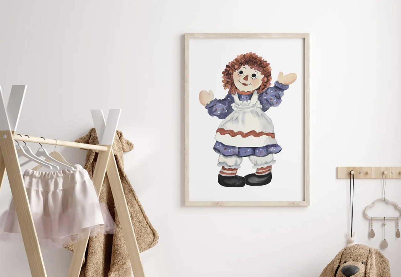 Raggedy Ann watercolor painting framed on a nursery wall.