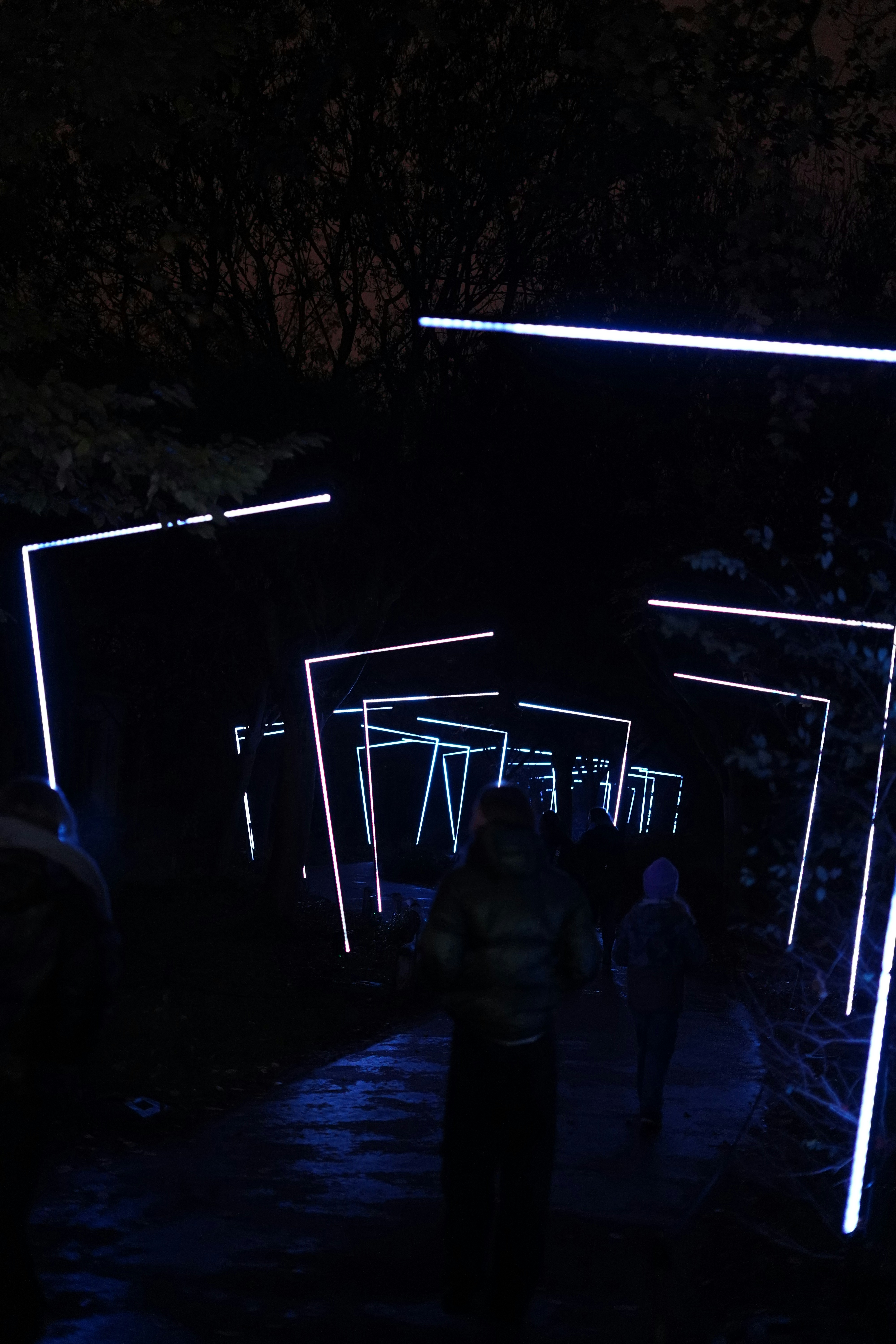 A group of people walking through a dark tunnel