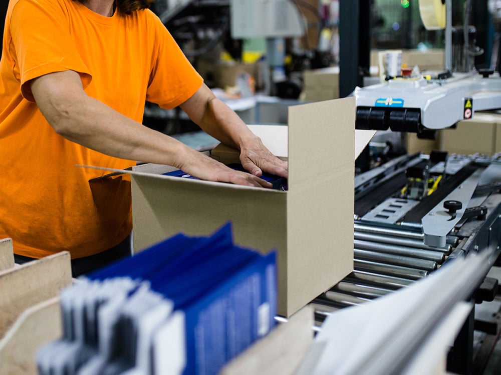 Worker's Hand Preparing Carton For Printing