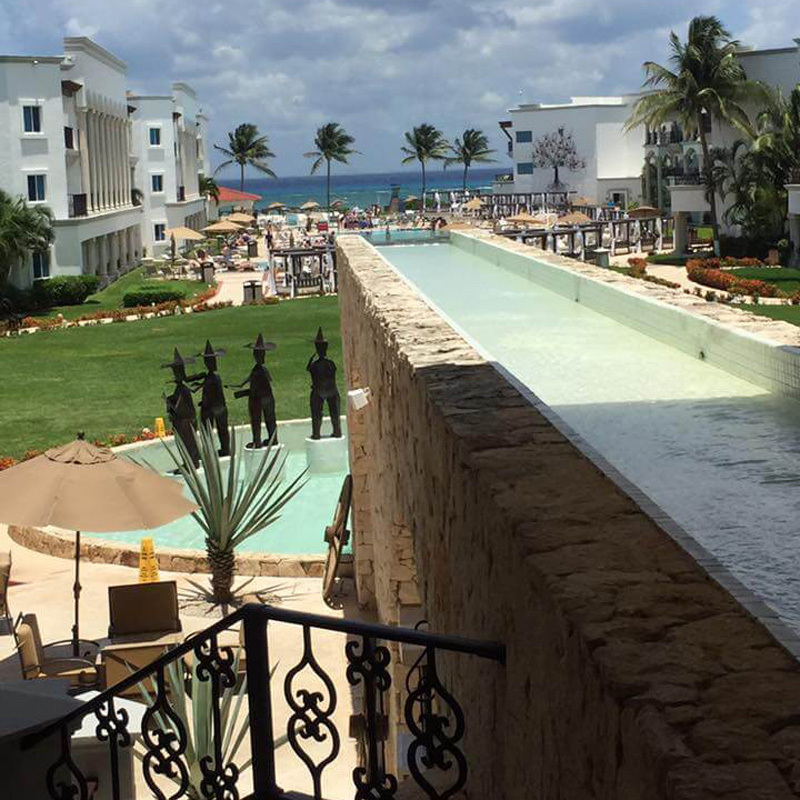 View of a decorative waterfall and pool in The Royal in Playa Del Carman.