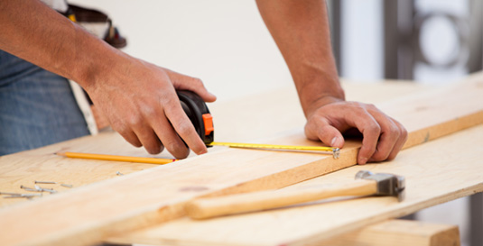 Worker Using a Tape Measure