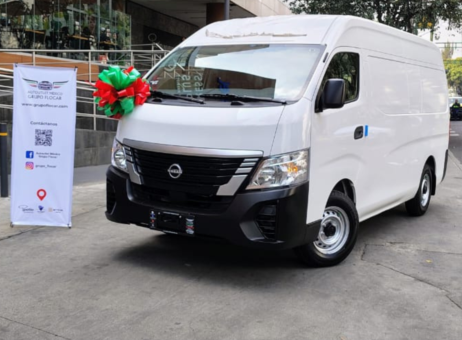 Three white pickup trucks, including Nissan and Toyota models, parked side by side in an underground parking garage.