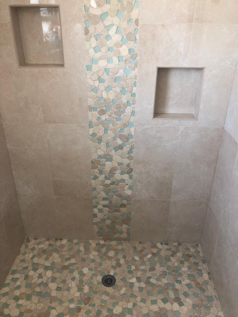 Decorative rock feature with matching rock shower floor.
