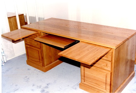 Desk has two slide out writing
 boards and a slide out keyboard.