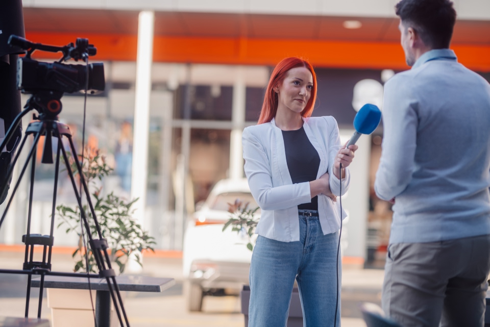 A woman using a microphone.