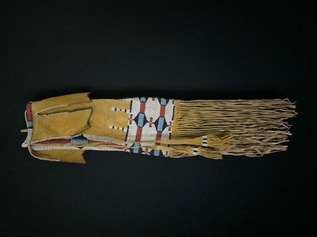 PRODUCT PROFILE :
Product No. :  #11216
Description :  Cheyenne Bar 
Design Pipebag
PRODUCT NARRATIVE:
• Sinew sewn buffalo hide.
• Painted with yellow ochre.
• Size: 23" length.
• Circa 1870's
