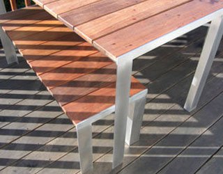 Made of Ipe and aluminum, this outdoor furniture set of two benches and a table was hand-built to match the client&apos;s existing deck.