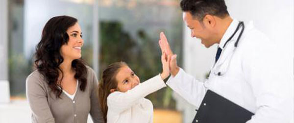 Little girl and paediatrician doing high five