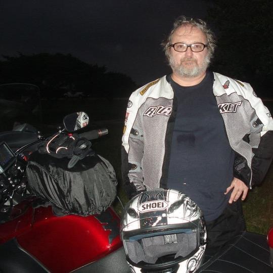 Steven Potter beside a motorcycle