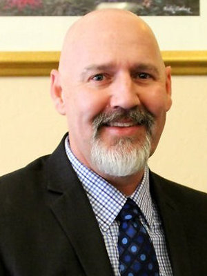A smiling man in a suit