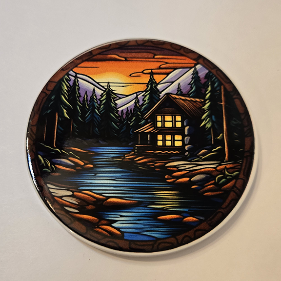 Round ceramic coaster with a stained glass cabin design