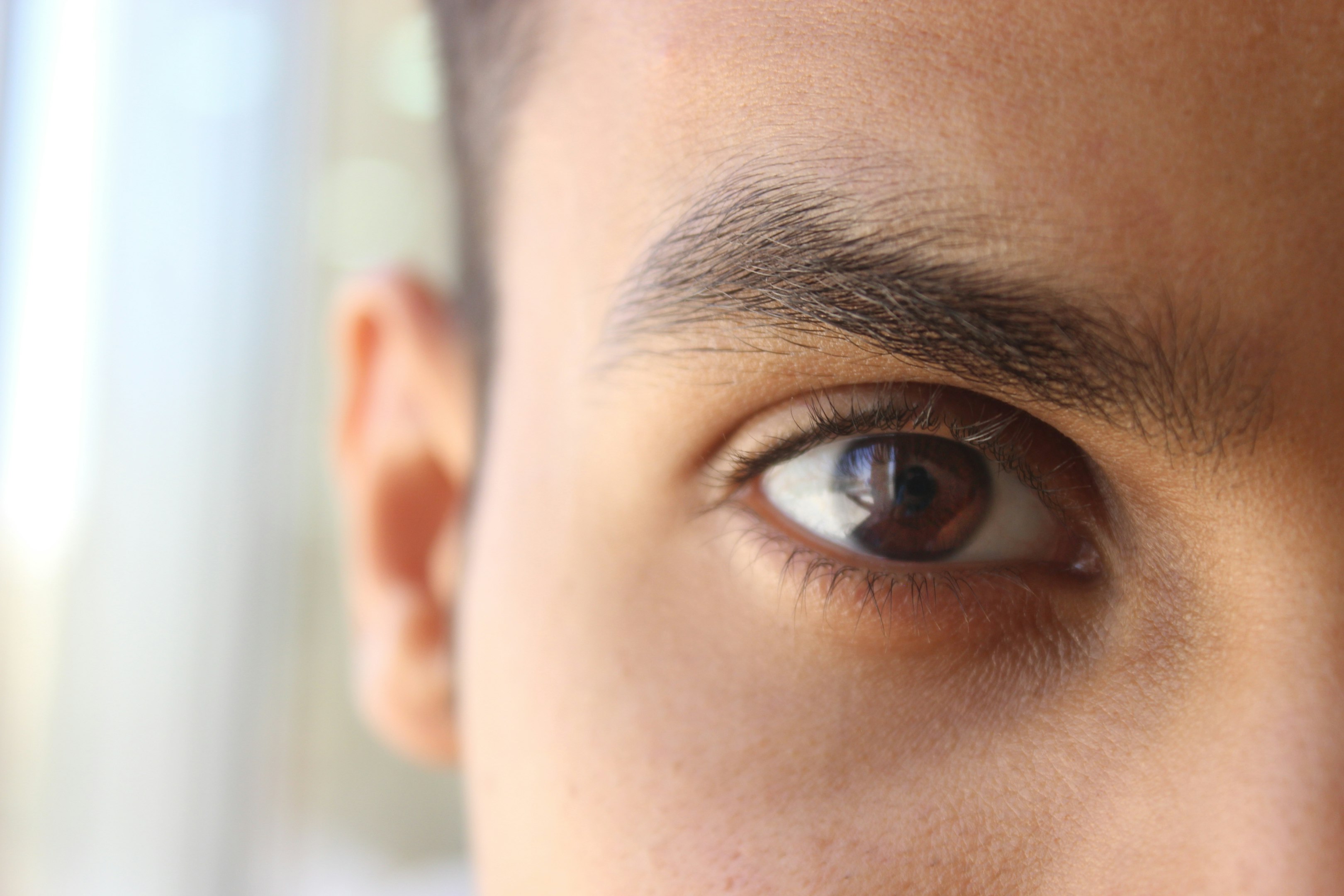 a close up of a person's eye with a blurry background