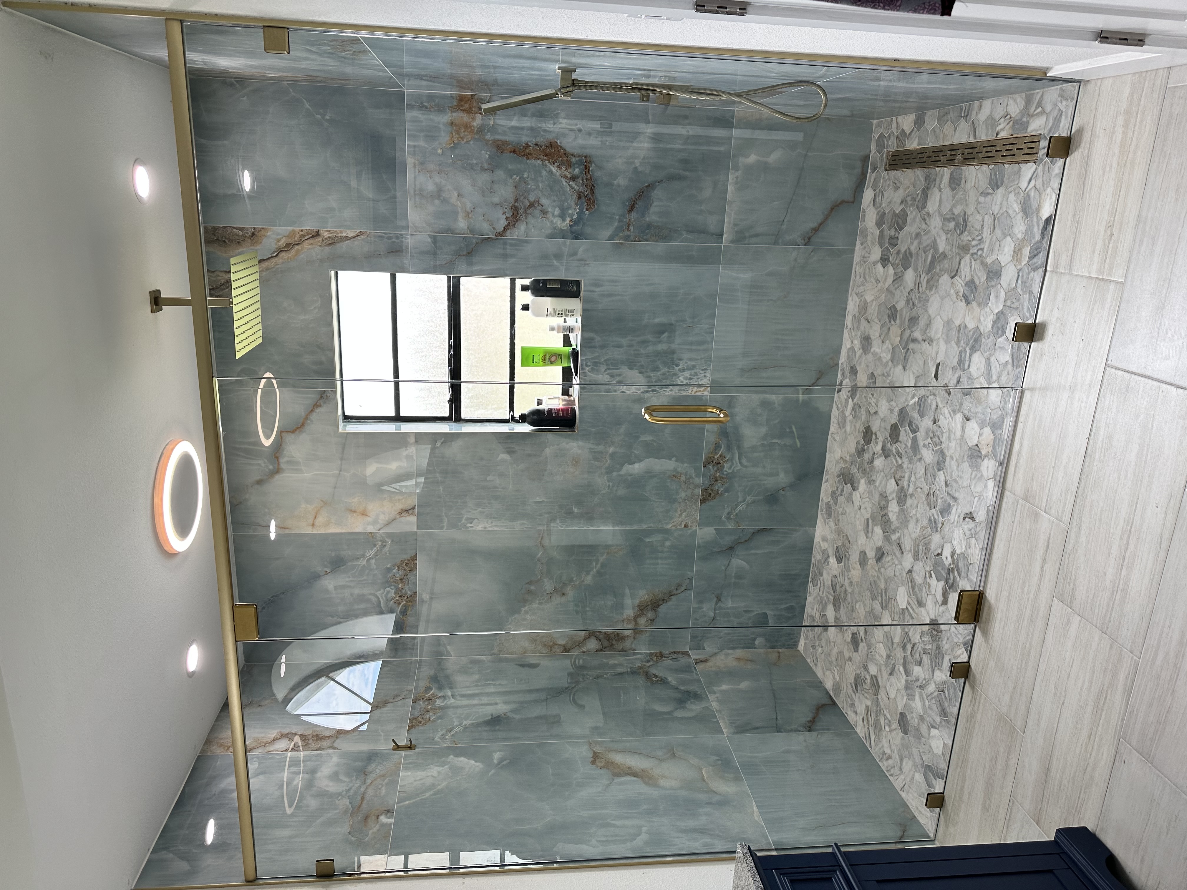 3/8" panel-door-panel with pivot hinge and header, satin brass metal installed by Pierce Lindsey Glass