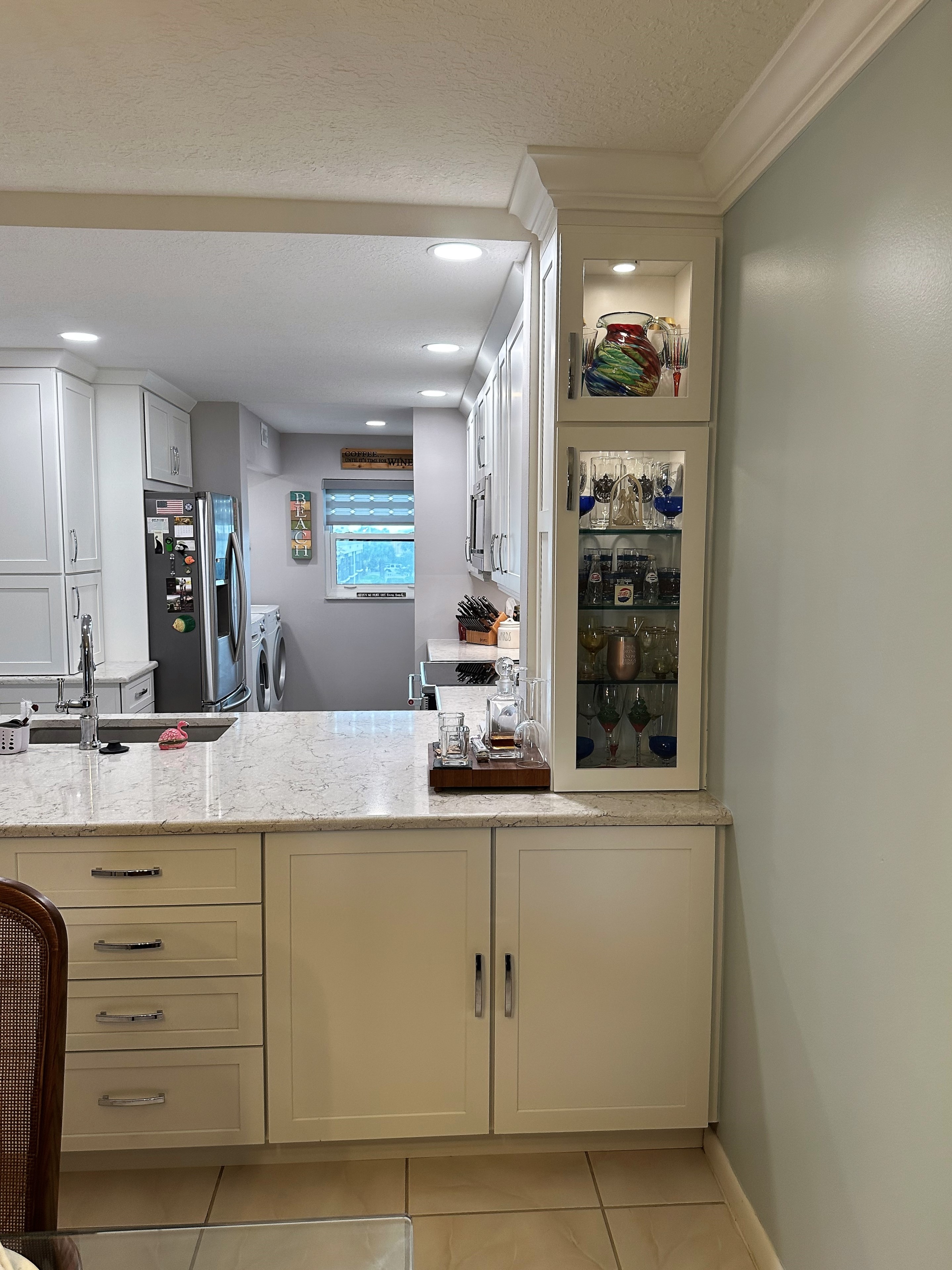 End cabinetry featuring glass door fronts and LED lighting to showcase keepsake items.