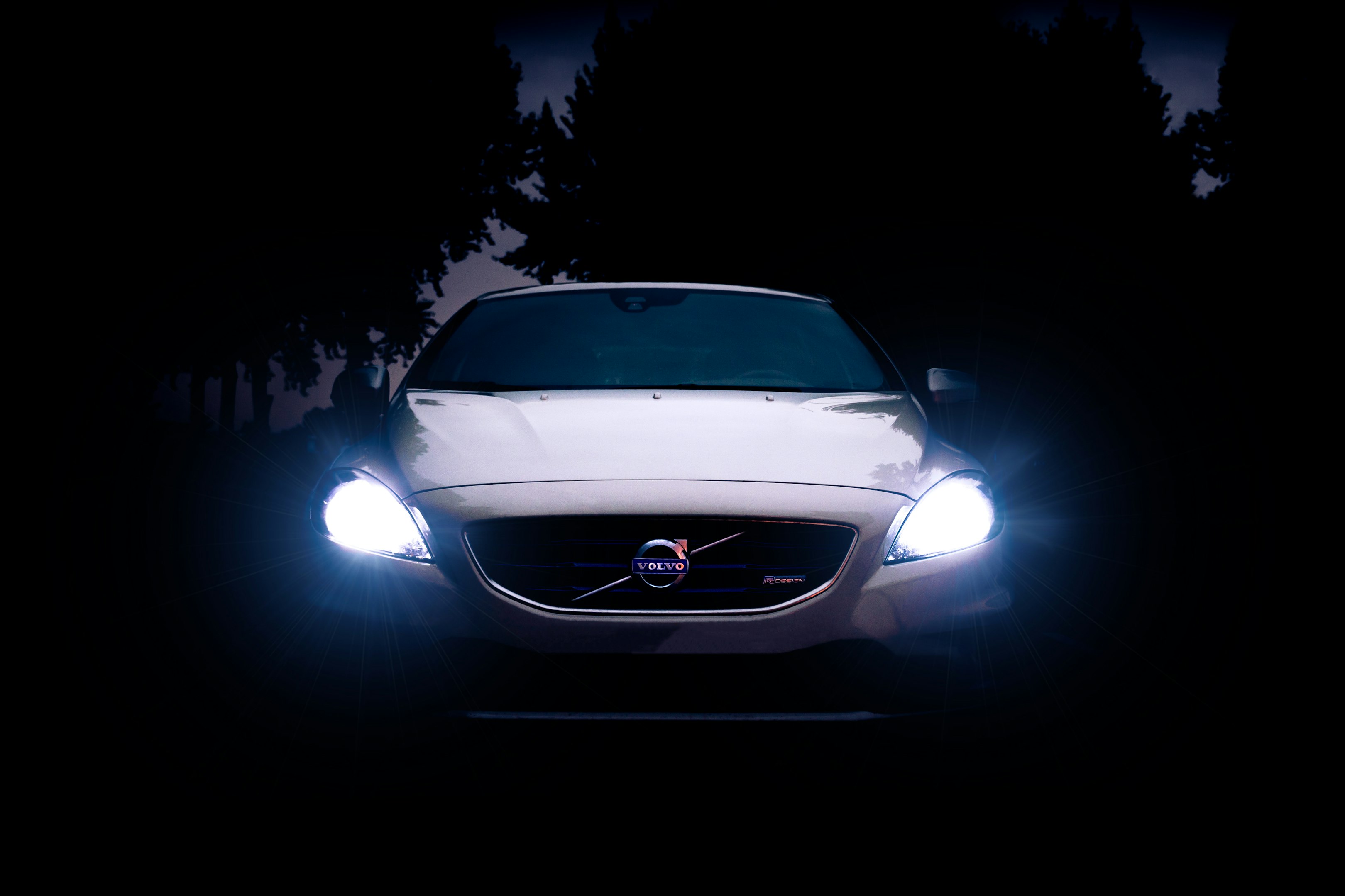 coche Volvo plateado con luces encendidas durante la noche