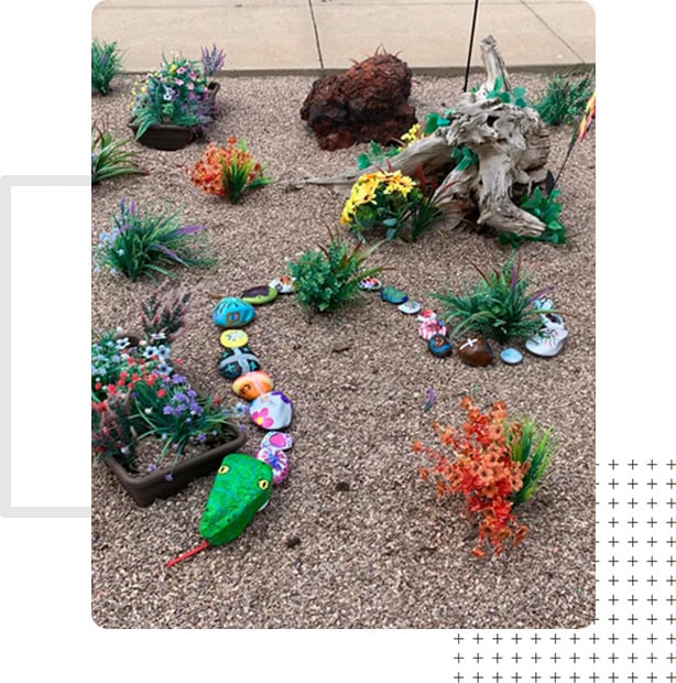 A garden with painted rocks and decor