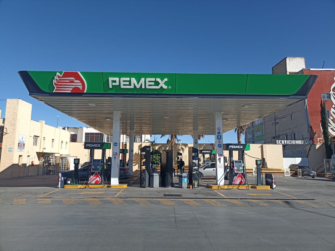 una estación de gasolina con un letrero