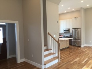 Foyer, family room, and kitchen areas displaying open floor plan.