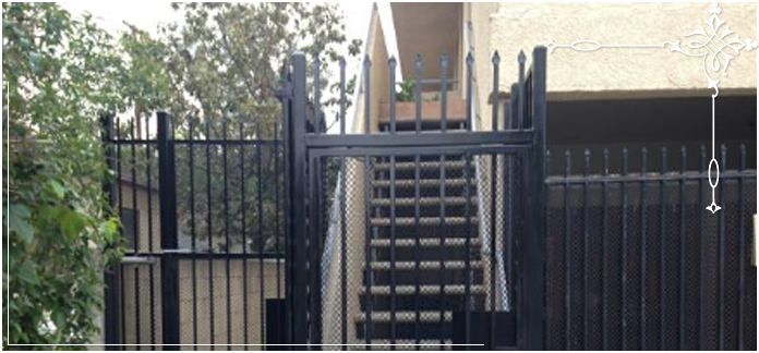 Black iron fence around stairs with locked entry. Black iron fence around stairs with locked entry.