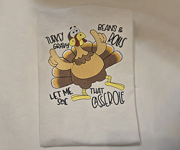 Embroidered dancing turkey on white adult apron