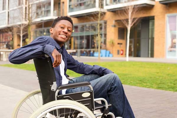 Happy Young Man In A Wheelchair