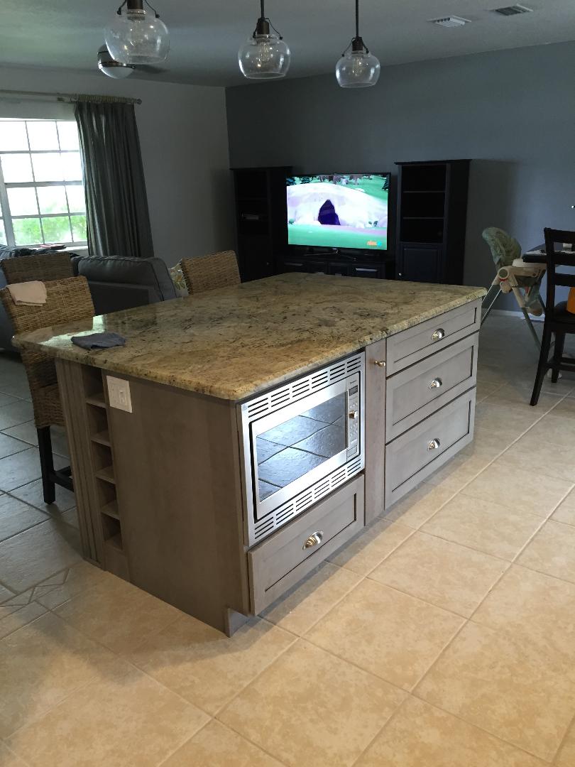 Custom Island featuring an undermounted microwave oven with additional storage.