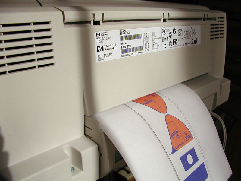 You need a printer that supports a straight through paper path. Shown here is an HP 1120 with paper fed from the back of the printer.