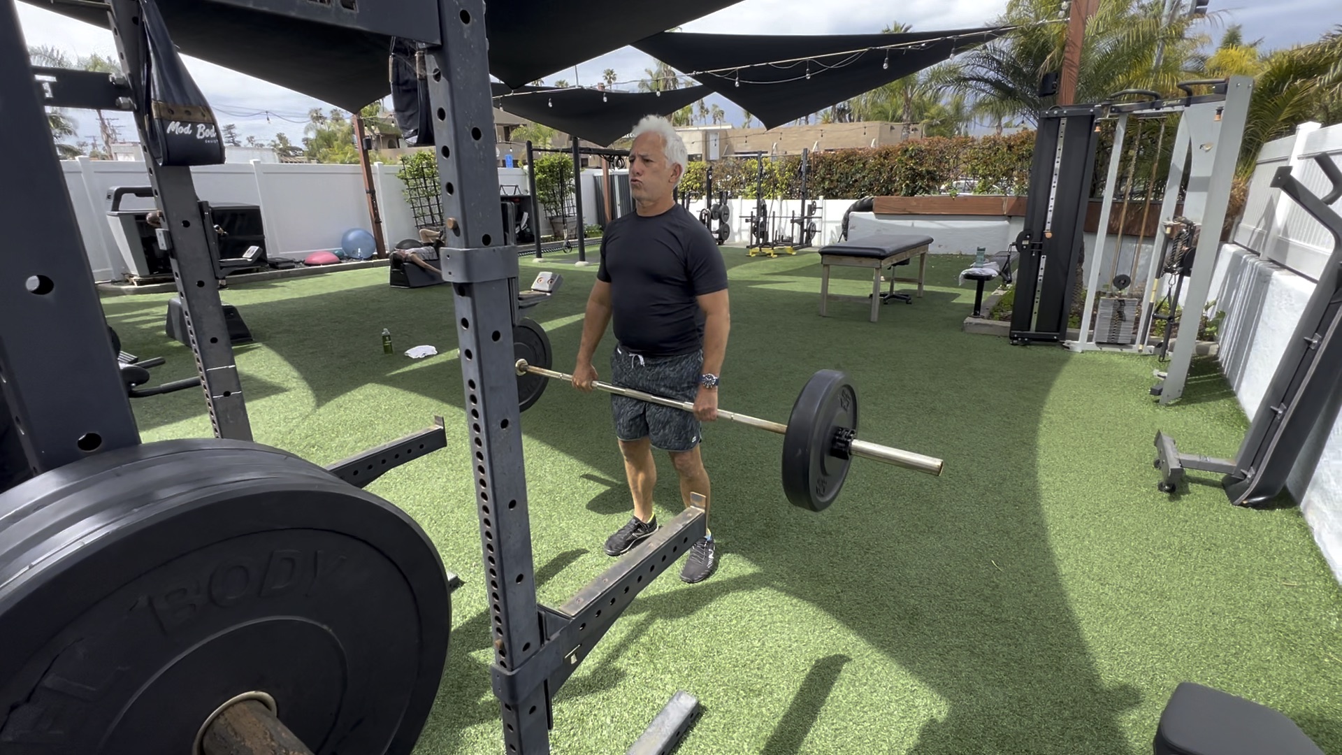 woman standing surrounded by exercise equipment