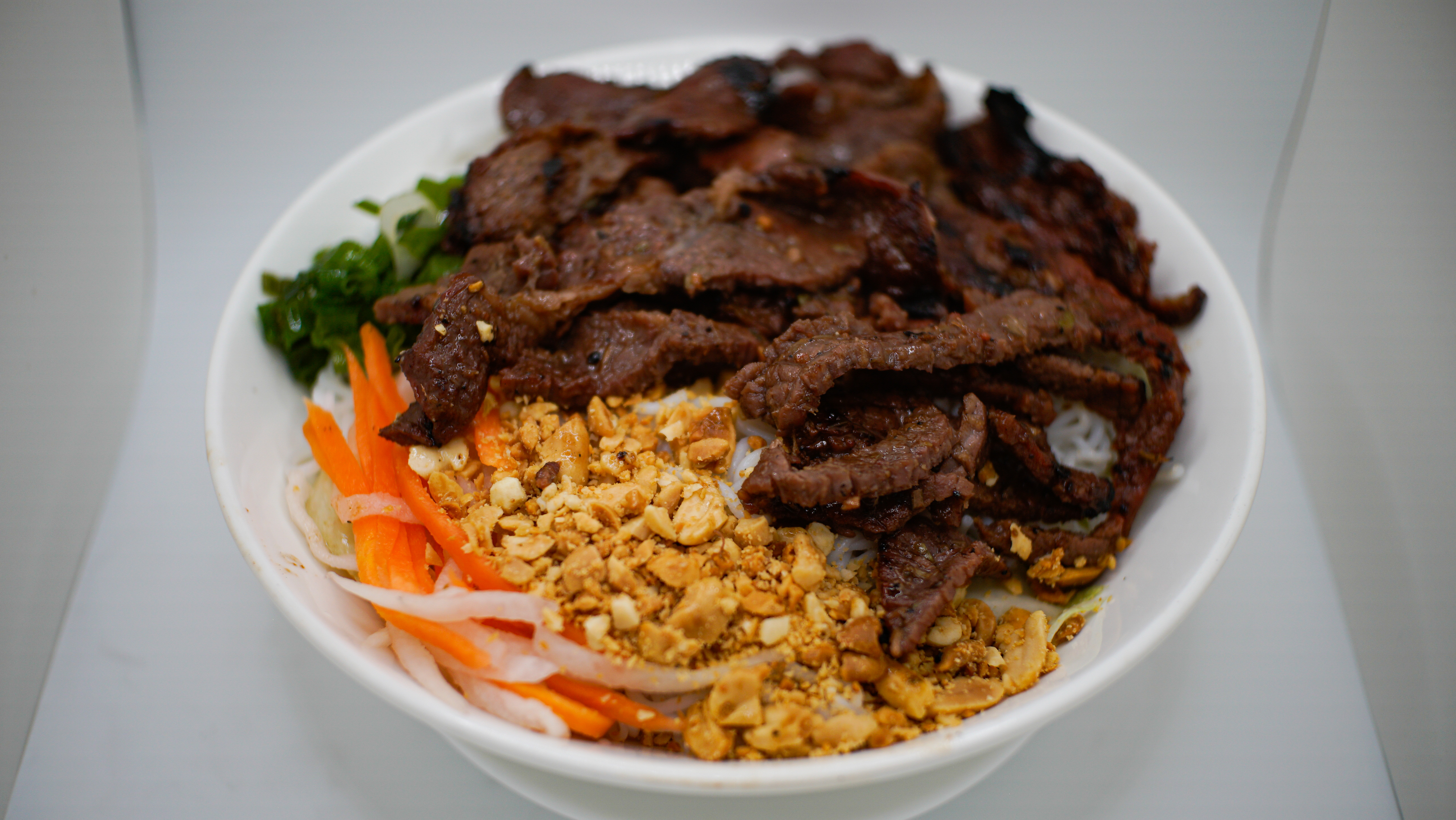 2B. BUN BO NUONG (G)
Grilled Beef Vermicelli
Noodle Bowl
Topped W/ Crushed Peanuts, 
Pickled Carrots/Radish and
Oiled Green Onions