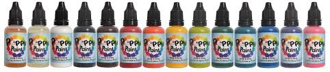 Colorful row of Pyo Paint bottles with black caps, displaying various vibrant shades.