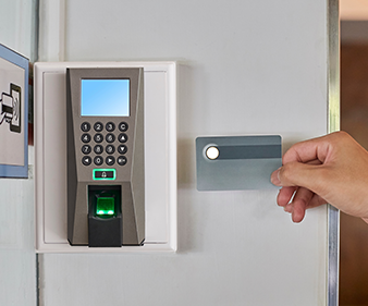 Young man or woman used key card for access digital door systems. People holding key card for unlocking door. Selective focus. Close up