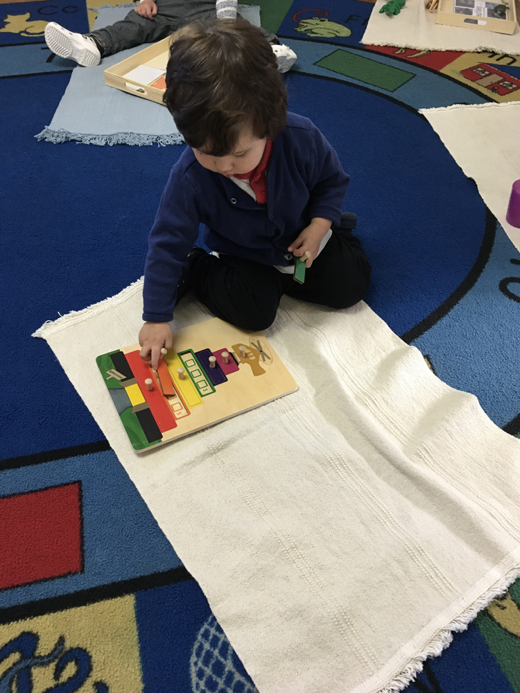 Young child playing with a wooden toy