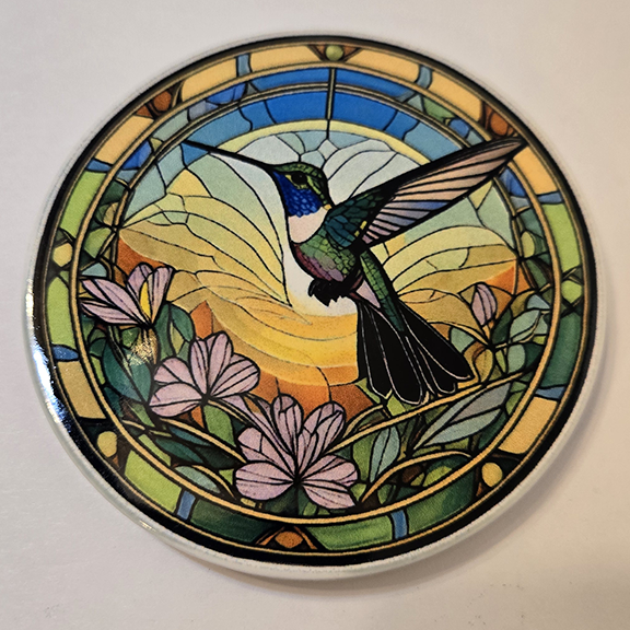 Round ceramic coaster with a stained glass hummingbird desing