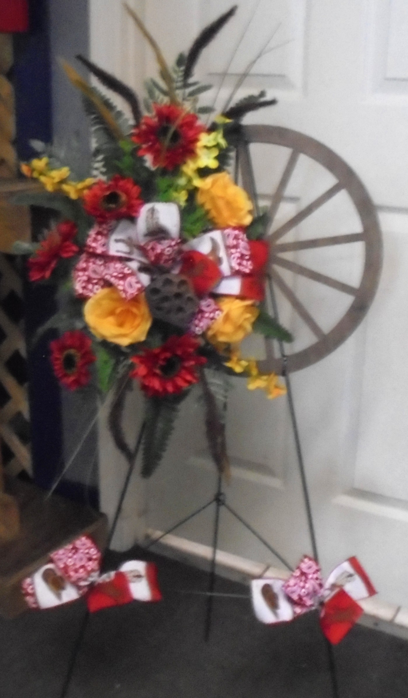 (26)  "SILK" Wagon-Wheel Wreath 
On Easel (Red & Yellow Mix)
$65.00
