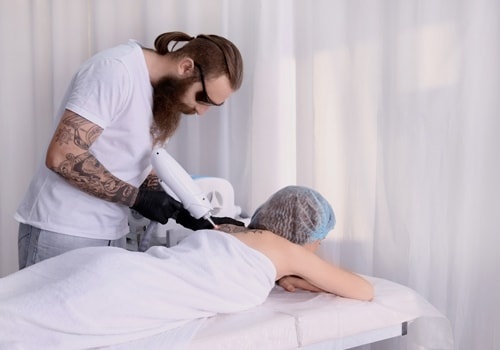 Cosmetologist With Patient And Professional Tattoo Removal Laser In Salon