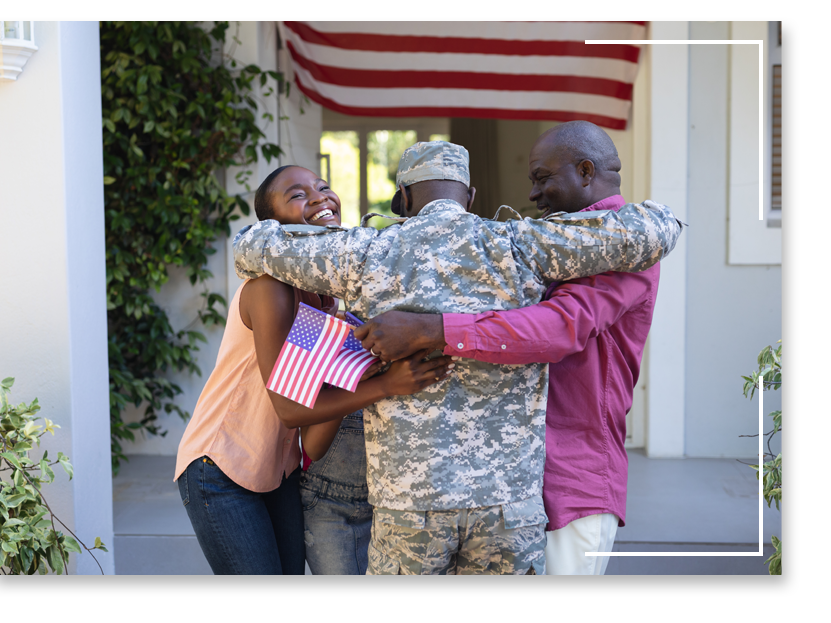 Military man hugging his parents in front of their home. Military man hugging his parents in front of their home.