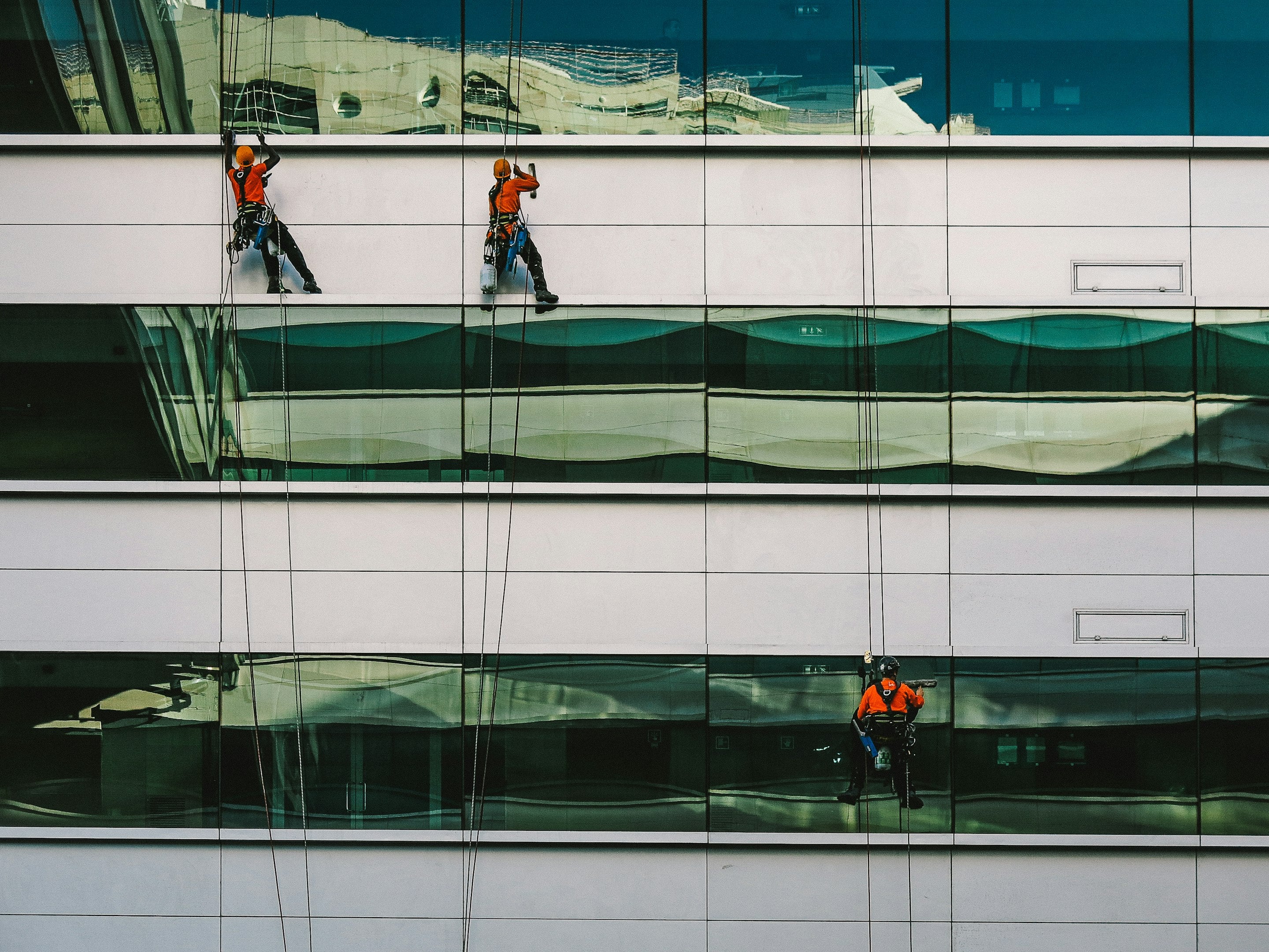 man cleaning white building