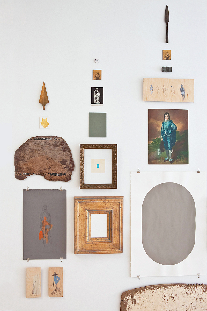 The Blue Boy, a grey painted oval and other art and objects arranged on a wall.