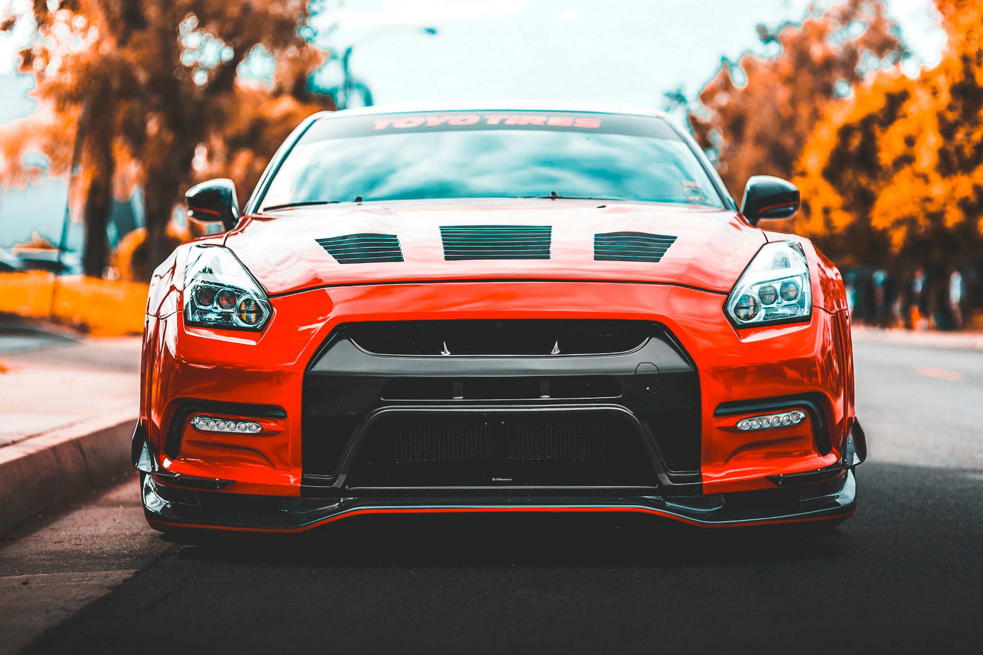 coche rojo cerca de árboles