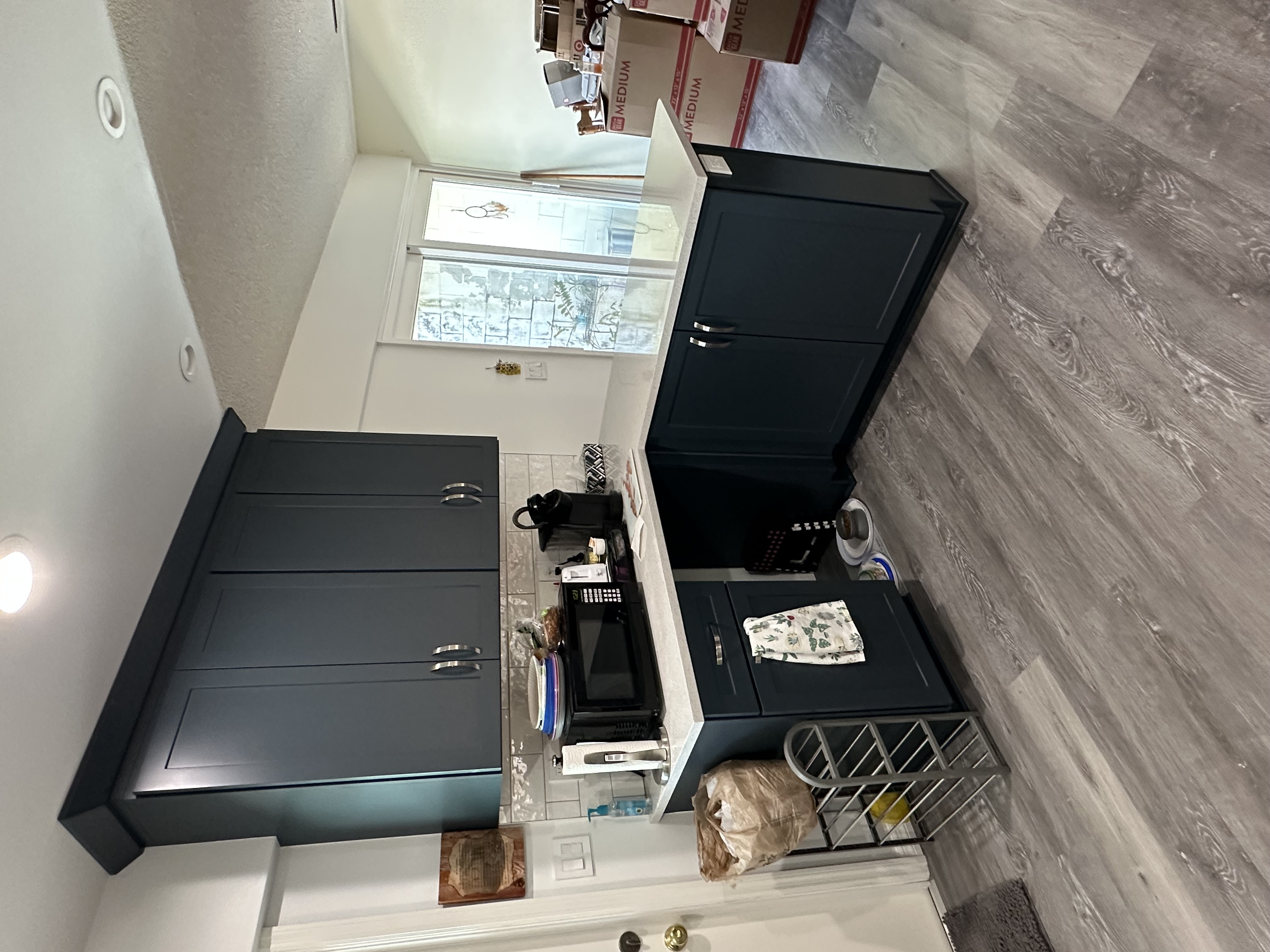 The semi-custom cabinetry peninsula, painted in Maritime, adds a bold pop of color and creates an eye-catching focal point in the kitchen.